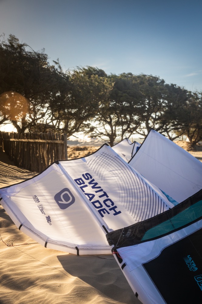 Cabrinha Switchblade kites laid out on the sand