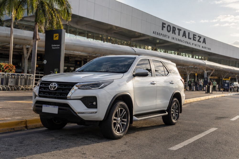 A white Toyota Hilux SW4 waiting outside Fortaleza International Airport
